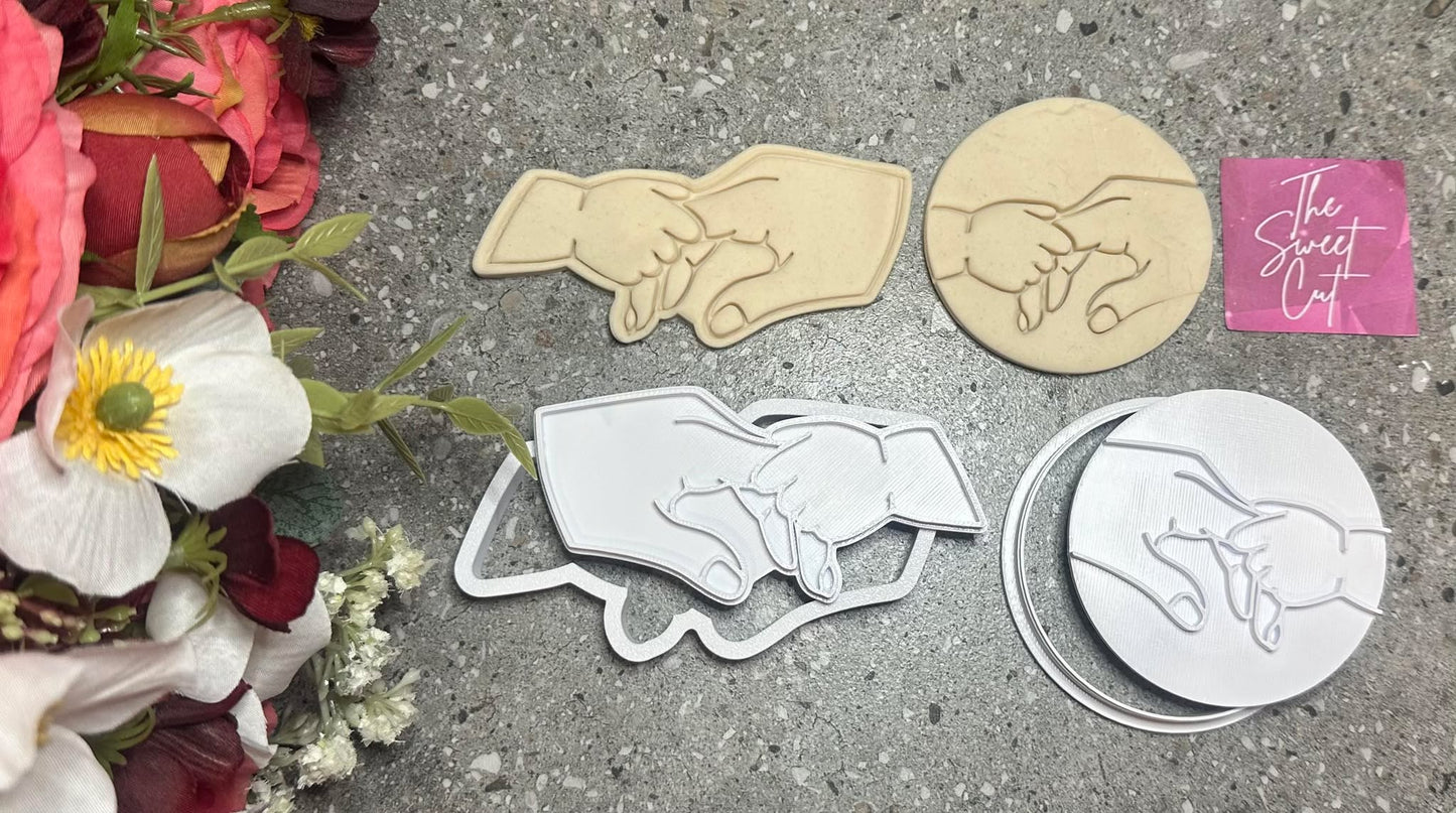 baby holding finger stamp and cutter