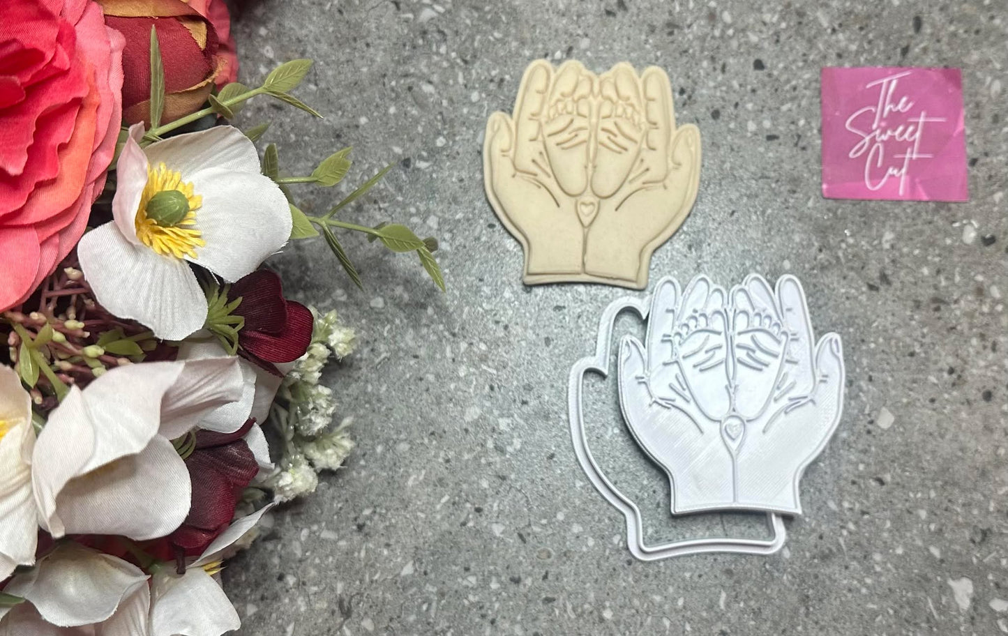 Hands holding feet stamp and cutter