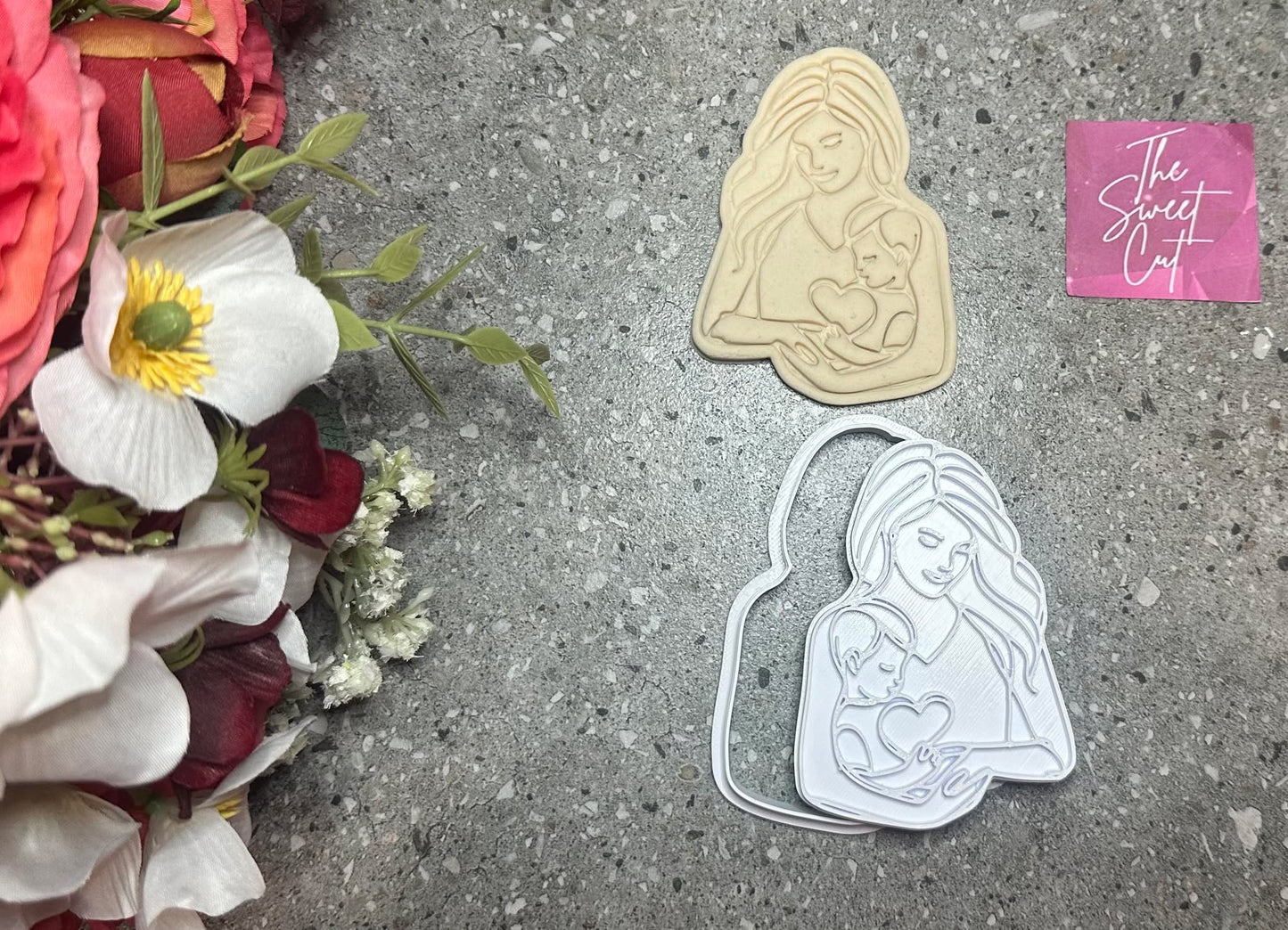 Mother holding baby stamp and cutter