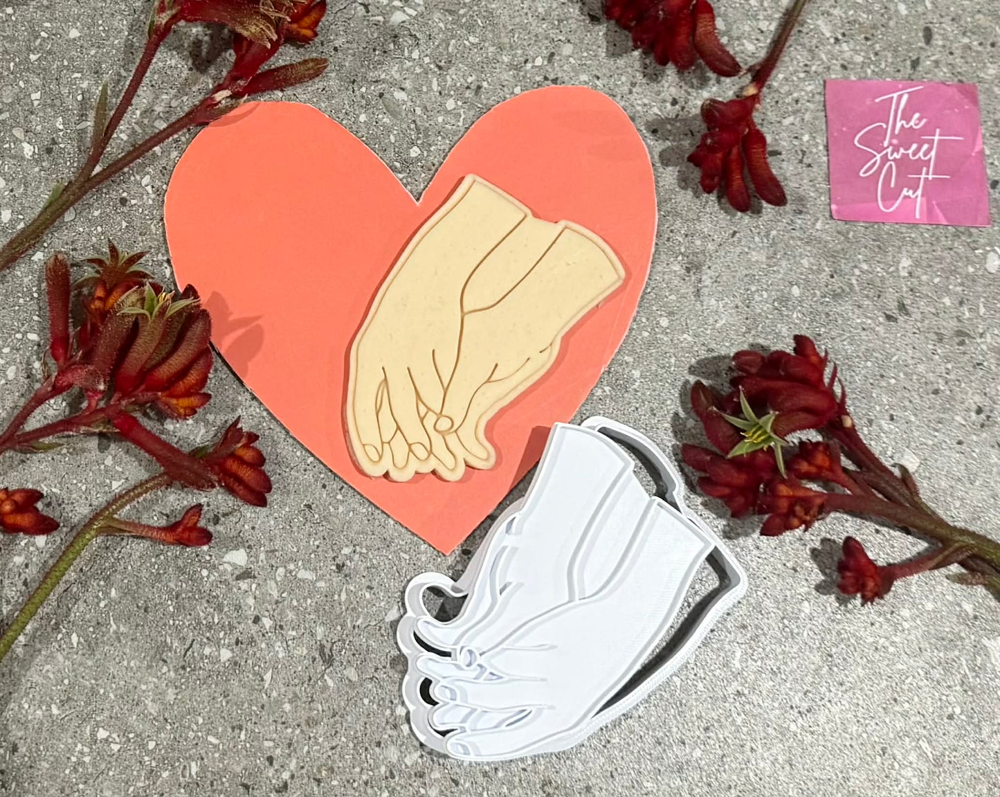Two Hands holding Stamp and Cutter